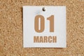 march 01. 01th day of the month, calendar date. White calendar sheet attached to brown cork board.Spring month, day of