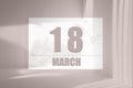 march 18. 18th day of the month, calendar date. White sheet of paper with numbers on minimalistic pink background with