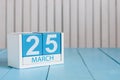 March 25th. Image of march 25 wooden color calendar on white background. Spring day, empty space for text.