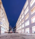 famous street Graben at night with the lights of shops and crowds of tourists walking around