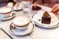 original authentic Viennese Sacher Torte cake served with whipped cream and cup of coffee at Royalty Free Stock Photo