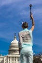 MARCH 24, 2018 - Washington DC, Female poses like Statue of Liberty in front of US Capitol,. Democracy, torch Royalty Free Stock Photo