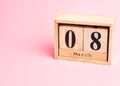 8 march wooden calendar on the pink background. Womens day concept. Copy space, close up, minimalism