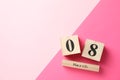 8 march wooden calendar on two tone background