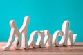 March - wooden carved word at turquoise background. Beginning of march month. Spring is coming