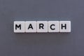March word made of square letter word on grey background Royalty Free Stock Photo