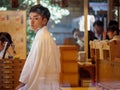 Trainee shinto priest sells omamori, Atsuta Shrine, Nagoya, Japan