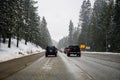 March 25, 2018 Yuba Pass / CA/ USA - Heavy traffic on I80 traversing the Sierra mountains, caused by adverse weather conditions Royalty Free Stock Photo