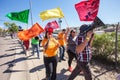 Marchers with colorful flags at border protest Royalty Free Stock Photo