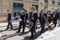 A Marching Band Plays in the Streets