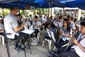 Marching band practice songs with their conductor before a performance