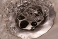 Marcro photography as water drains into the sink