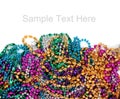 Mardi gras beads on white with copy space Royalty Free Stock Photo