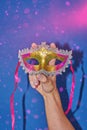 Mardi Gras masquerade mask on blue with confetti, copy space Royalty Free Stock Photo