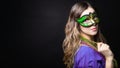 Mardi gras party, masquerade. Woman with a carnival mask and beads on the black background with copy space, banner Royalty Free Stock Photo