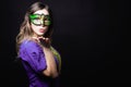 Mardi gras party, masquerade. Woman with a carnival mask and beads on the black background with copy space