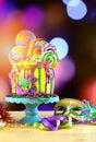 Mardi Gras theme on-trend candyland fantasy drip cake. Royalty Free Stock Photo