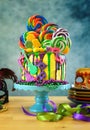 Mardi Gras theme on-trend candyland fantasy drip cake. Royalty Free Stock Photo