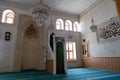 View from the interior of the Kasim TuÃÅ¸maner Mosque in Mardin, Turkey. Undefined man prays in mosque.