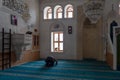 View from the interior of the Kasim TuÃÅ¸maner Mosque in Mardin, Turkey. Undefined man prays in mosque.