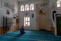 View from the interior of the Kasim TuÃÅ¸maner Mosque in Mardin, Turkey. Undefined man prays in mosque.