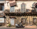 The exterior facade of an old Portuguese era house with vintage windows