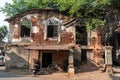 Ruins of an ancient Portuguese era building with vintage windows in the town of Madgaon