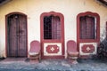 Vintage stone peaches on the porch of an old Portuguese era house with arched doors and windows