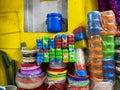 Colorful plastic cups, bowls and boxes stacked outside a shop for sale in a market Royalty Free Stock Photo