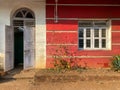 Exterior facade with an arched door and window of a traditional house in Goa