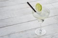 Margarita cocktail with lime on white woodenbackground