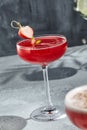 Margarita cocktail on tray table with summer sunlight and shadow. Red margarita drink with strawberry and lime peel. Alcohol Royalty Free Stock Photo