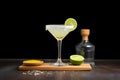 margarita glass with lime and salted rim, tequila bottle behind Royalty Free Stock Photo