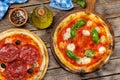 Margarita and pepperoni pizza with tomatoes, mozzarella cheese and basil Royalty Free Stock Photo