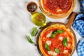 Margarita and pepperoni pizza with tomatoes, mozzarella cheese and basil Royalty Free Stock Photo