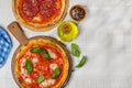 Margarita and pepperoni pizza with tomatoes, mozzarella cheese and basil Royalty Free Stock Photo