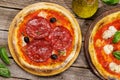 Margarita and pepperoni pizza with tomatoes, mozzarella cheese and basil Royalty Free Stock Photo