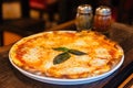 Margarita pizza topping with basil leaves served with oregano and chili powder Royalty Free Stock Photo