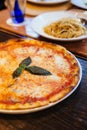 Margarita pizza topping with basil leaves served with oregano and chili powder Royalty Free Stock Photo