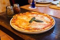 Margarita pizza topping with basil leaves served with oregano and chili powder Royalty Free Stock Photo