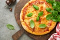 Margarita pizza. Traditional neapolitan margarita pizza and cooking ingredients tomatoes basil on old concrete texture background Royalty Free Stock Photo