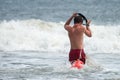 MARGATE CITY, NJ - AUGUST 8: Margate City Lifeguard running into the Atlantic Ocean to rescue a swimmer in distress