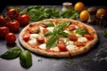 a margherita pizza with fresh ingredients tomatoes, mozzarella, basil on a marble countertop Royalty Free Stock Photo