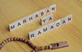 marhaban ya ramadan or welcome islamic fasting moth text on wooden square.