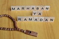 marhaban ya ramadan or welcome islamic fasting moth text on wooden square.