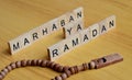 marhaban ya ramadan or welcome islamic fasting moth text on wooden square