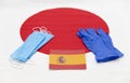 Mari El, Russia - June 16, 2021: Spanish flag with latex blue gloves and masks. The Japanese flag background. Tourist trip