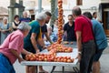 People tying tomatoes together to form the hanging bunches during Tomato `Ramellet` Night Fair in Maria de la Salut Royalty Free Stock Photo