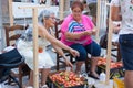 Women tying tomatoes together to form the hanging bunches during Tomato `Ramellet` Night Fair Royalty Free Stock Photo