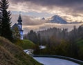 Maria Gern pilgrimage church and mount Watzmann top silhouette through fog, Berchtesgaden, Germany Royalty Free Stock Photo